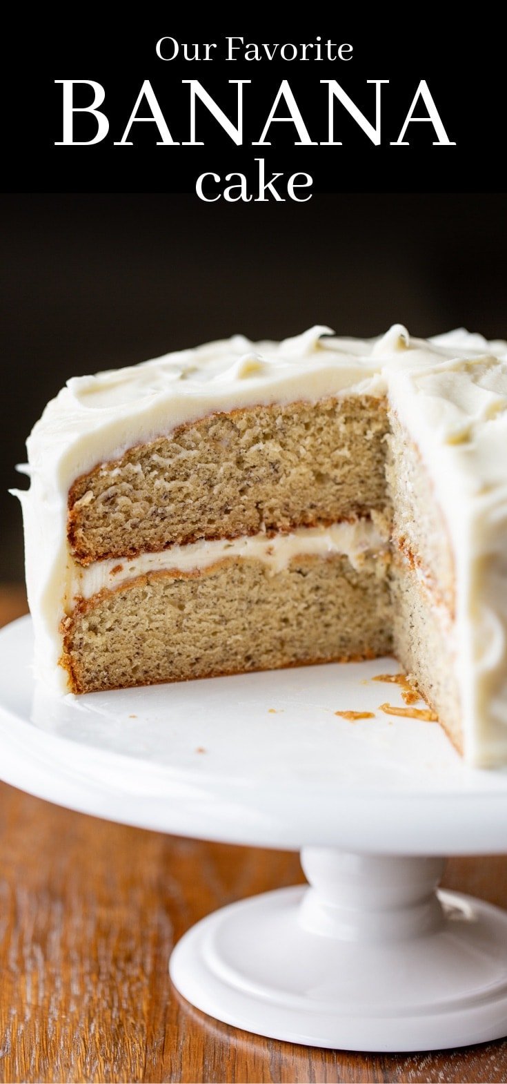 A frosted 2 layer banana cake on a cake stand upward Our BEST Banana Cake Recipe