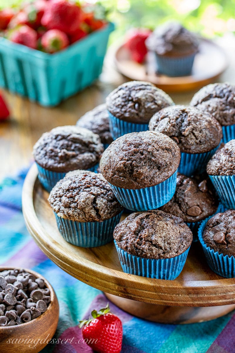 A cake tray filled with dark chocolate muffins with nice rounded top coated with coarse sugar