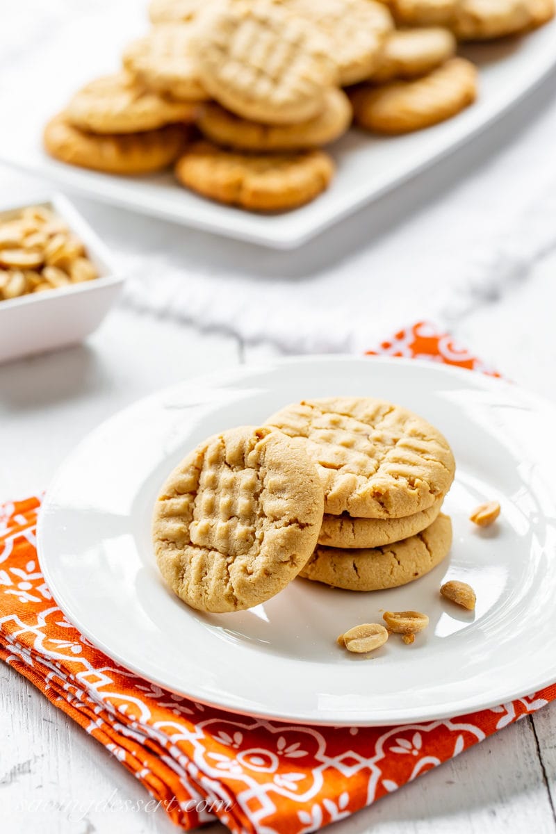 A plate of traditional peanut butter cookies with extra peanuts