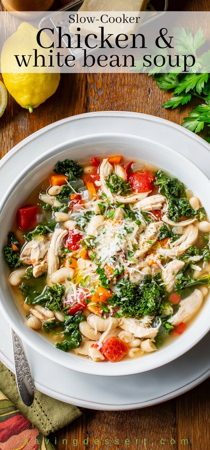 A bowl of healthy Chicken and White Bean Soup with kale, tomatoes and carrots