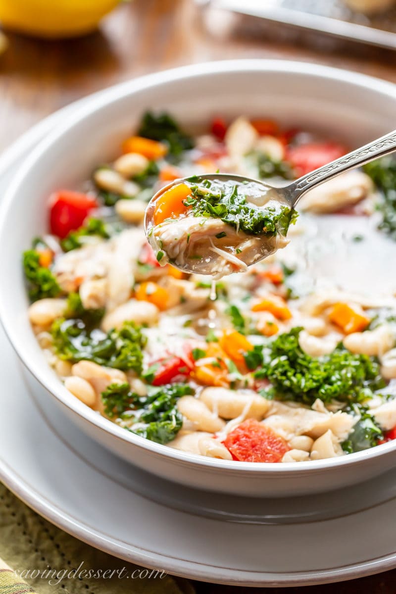 A bowl of slow-cooker chicken and white bean soup with kale