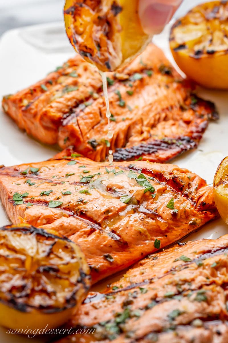 Juicy salmon fillets drizzled with the juices of a grilled lemon