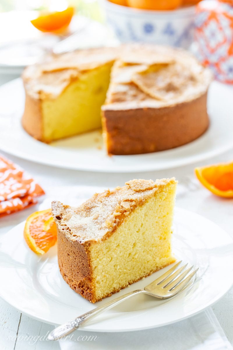 A big tall slice of Orange Olive Oil Cake with sliced Cara Cara oranges