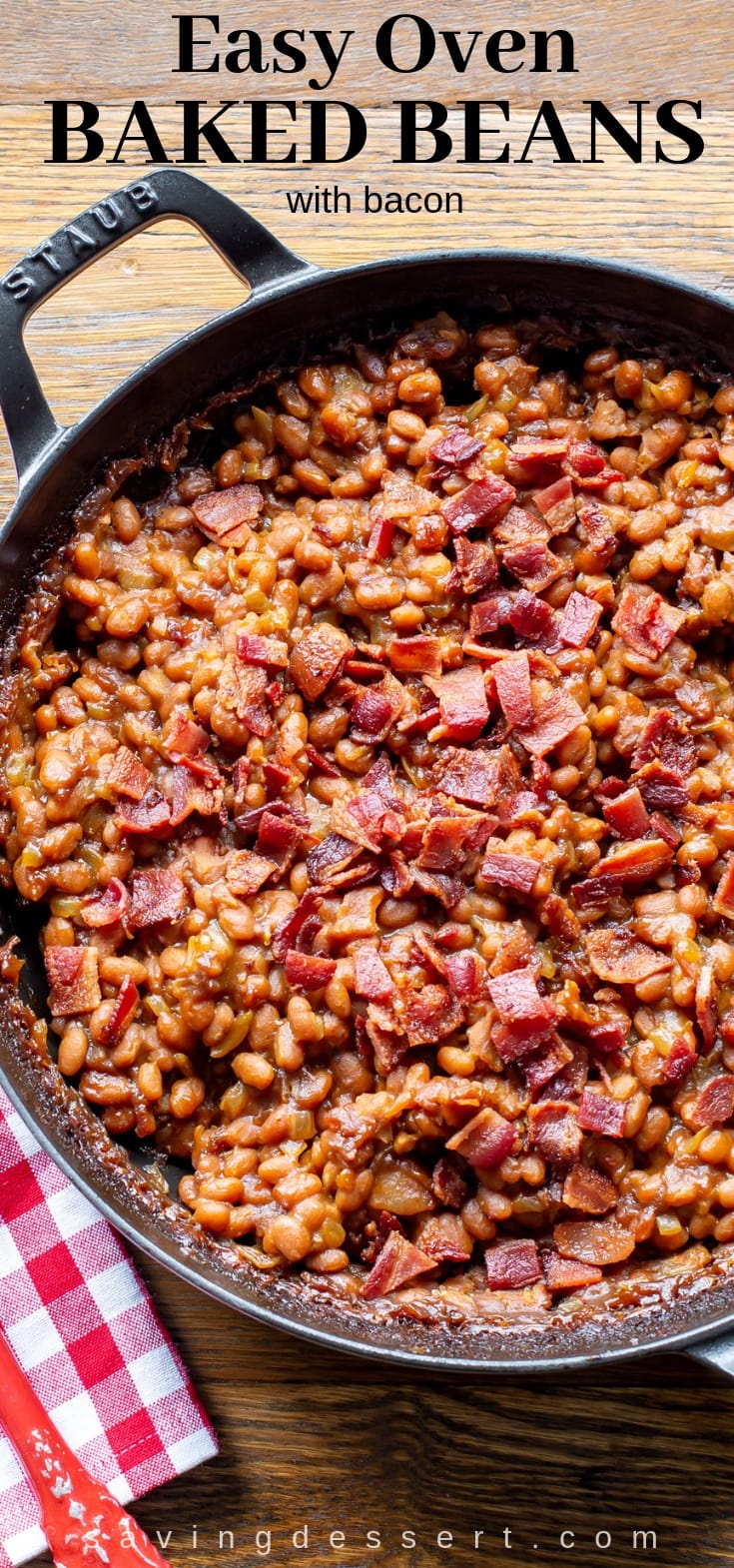 A big casserole dish with oven baked beans topped with crumbled bacon