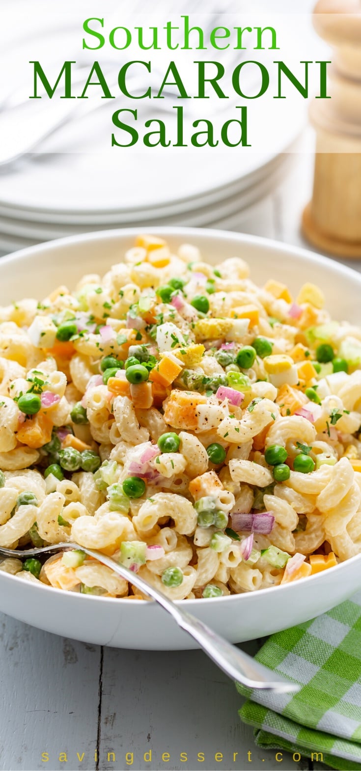 A bowl of macaroni salad with peas and cheese