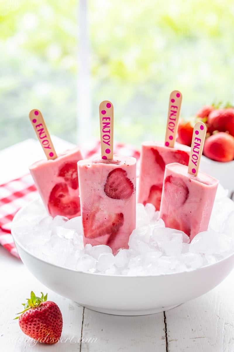 A bowl of fresh strawberry yogurt popsicles