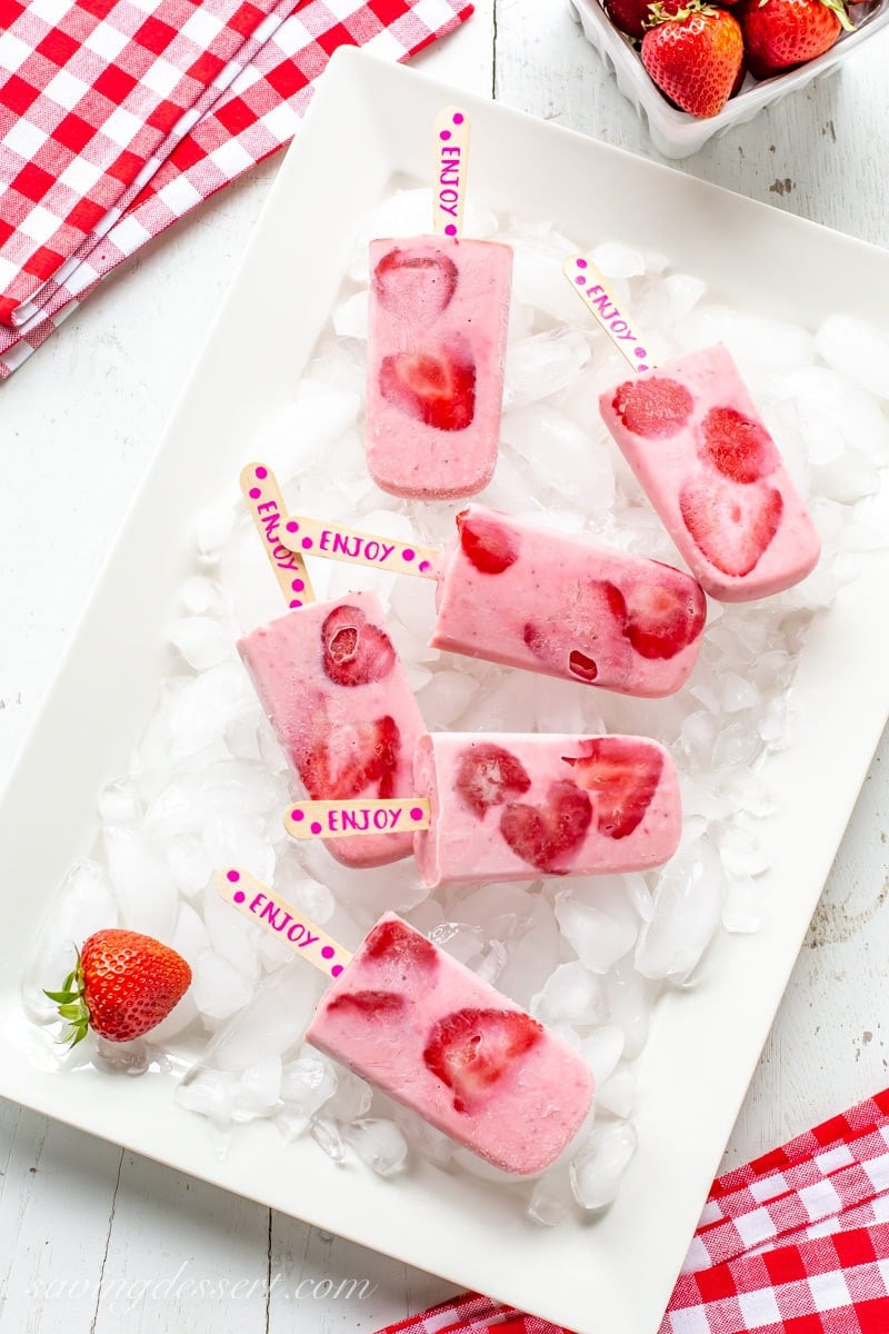 A platter of frozen strawberry yogurt popsicles