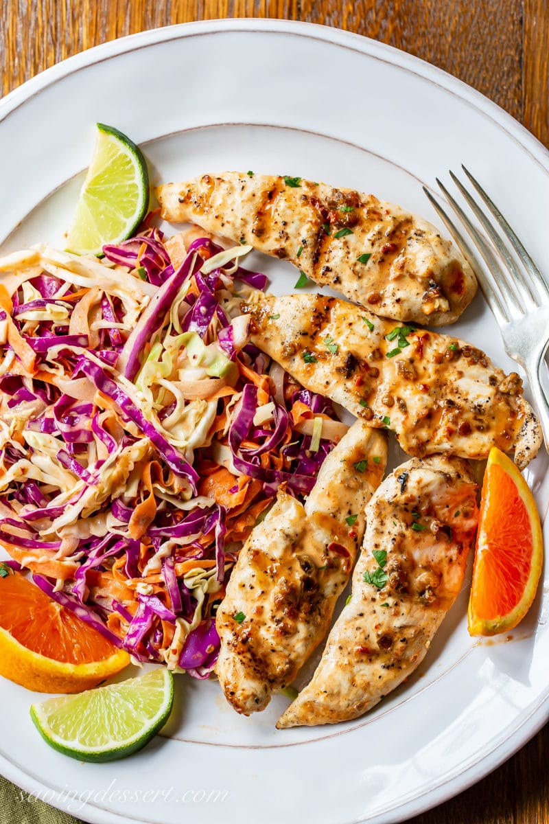 A plate with spicy purple slaw and grilled chicken tenders