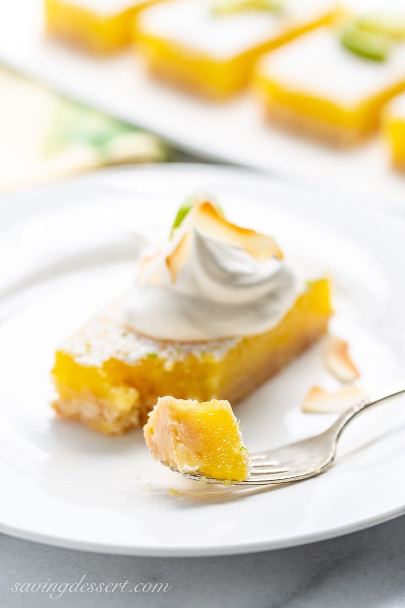 Coconut Key Lime Bar topped with whipped cream and toasted coconut