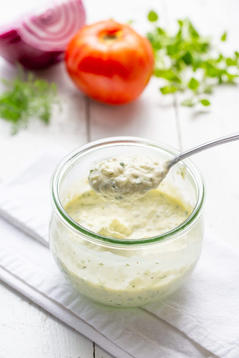 A jar filled with fresh cucumber-yogurt sauce