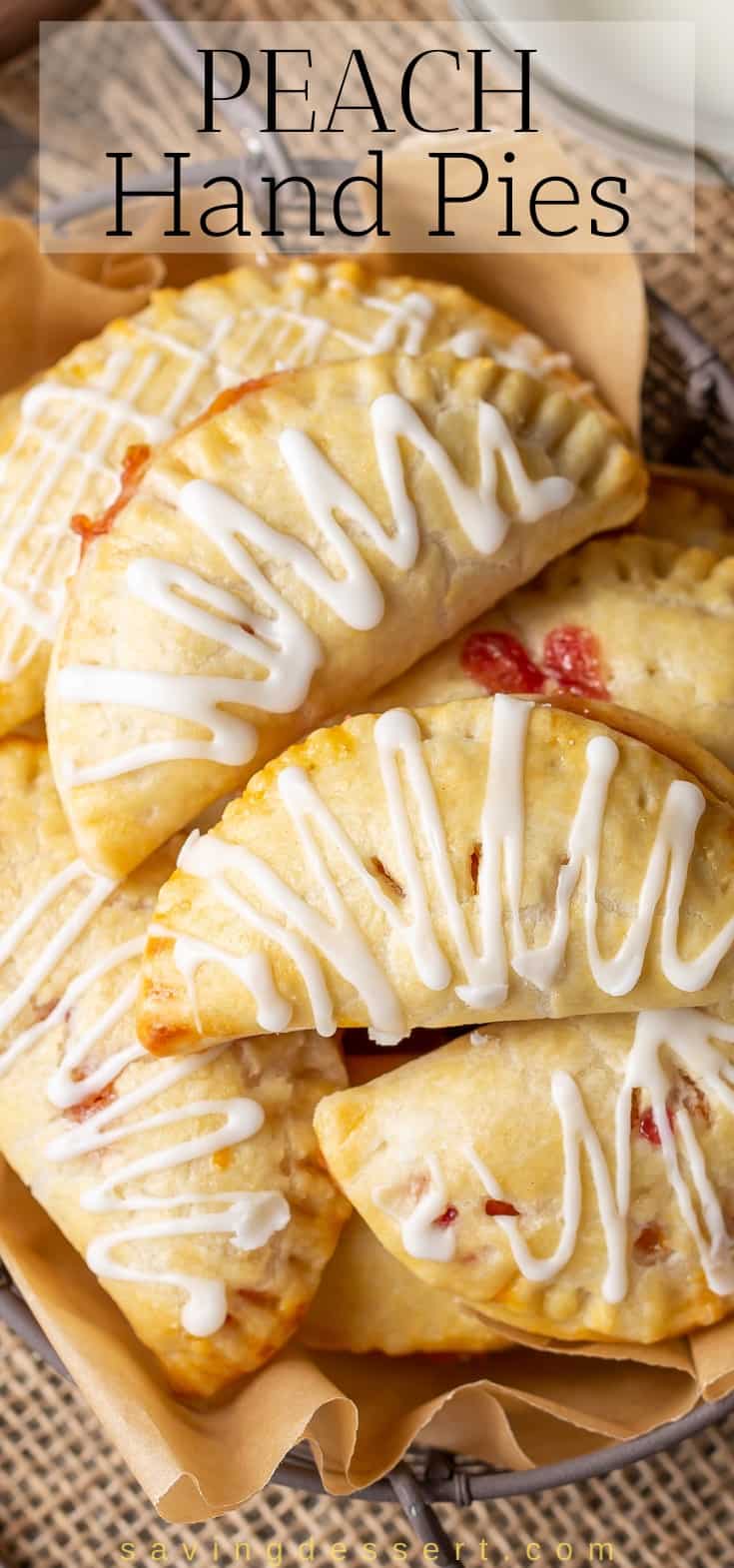 A stack of homemade peach hand pies drizzled with icing