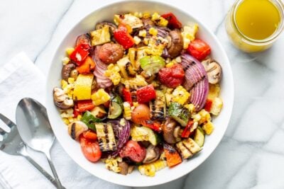 A bowl of chopped grilled vegetables amongst eggplant Chopped Grilled Vegetables