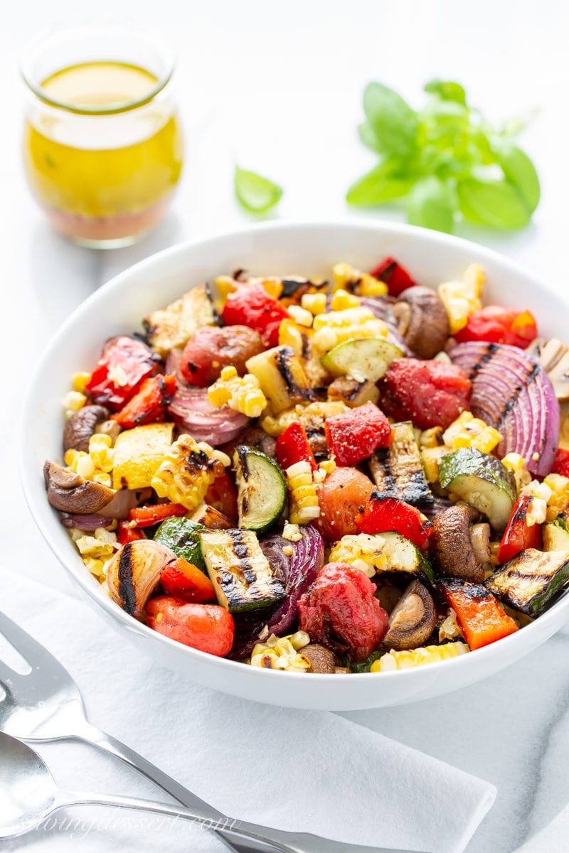 A bowl of chopped grilled vegetables with a simple viniagrette