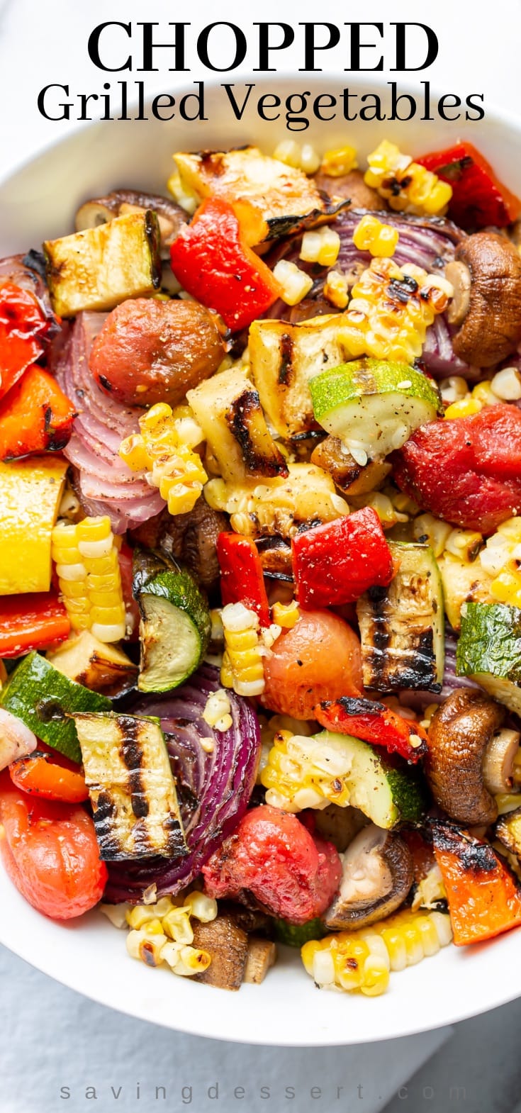 Grilled vegetables in a bowl - corn, squash, eggplant, onion, peppers and tomatoes