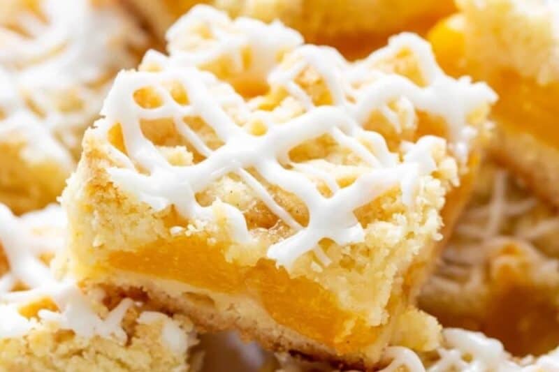 A platter of iced fresh peach crumb bars.