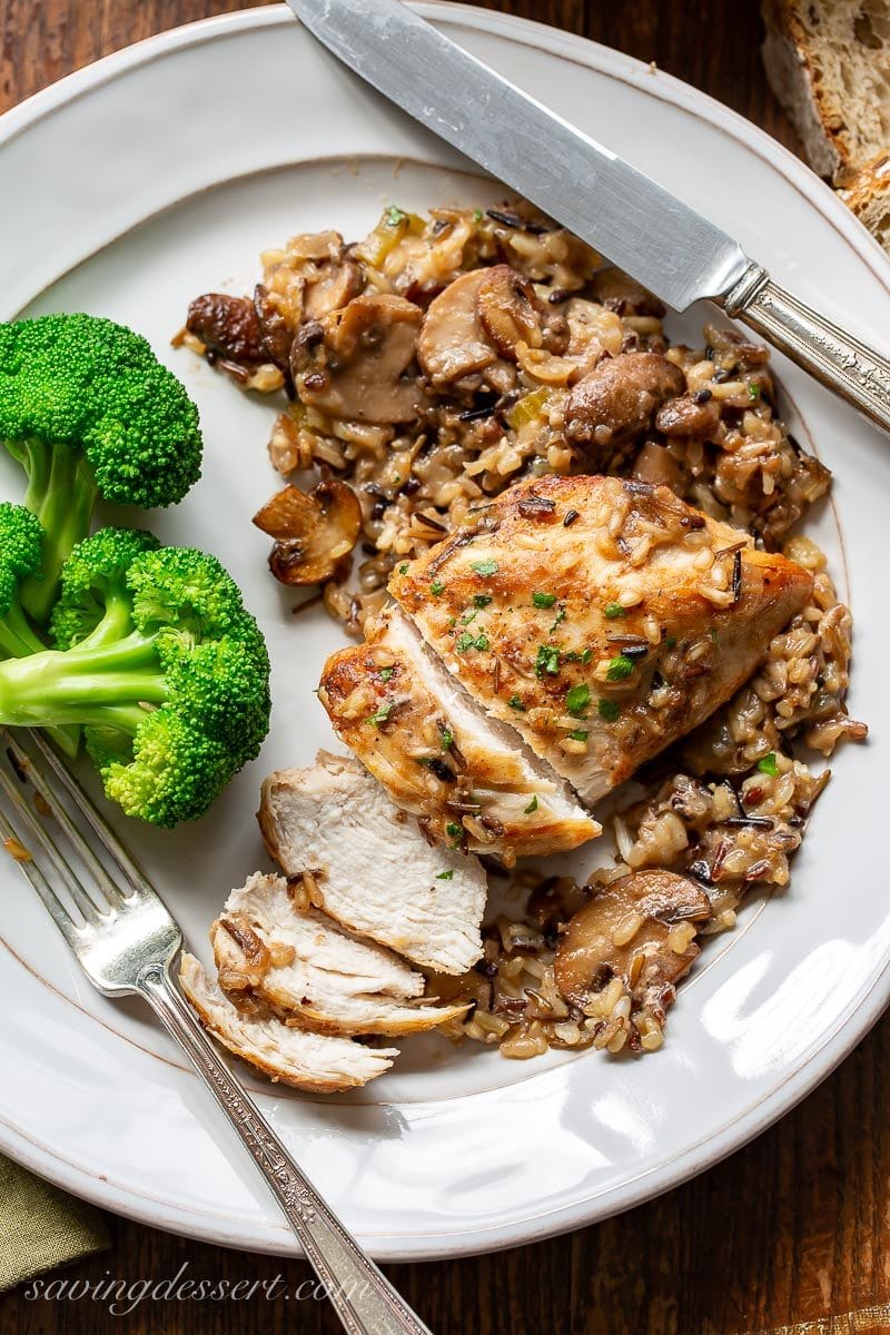a plate with broccoli, sliced chicken breast and wild rice casserole