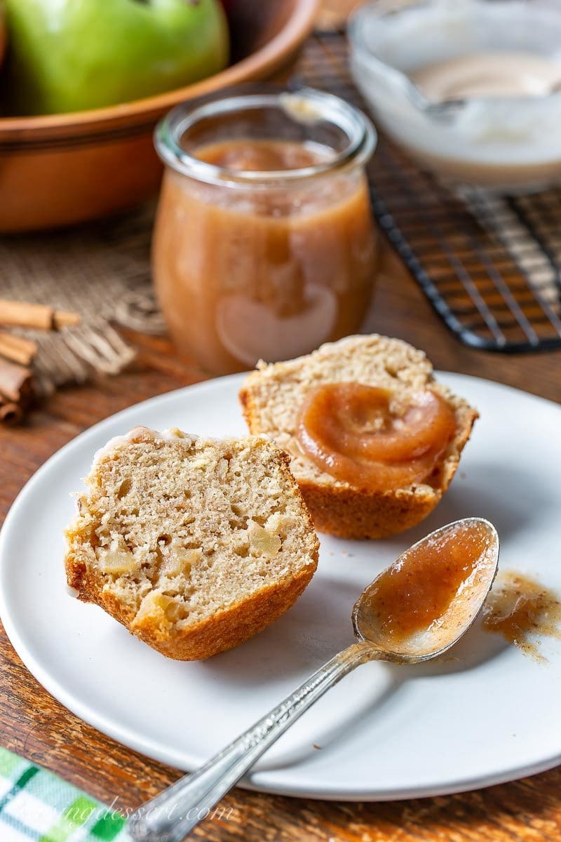 A cinnamon apple muffin sliced open and topped with maple pear apple butter