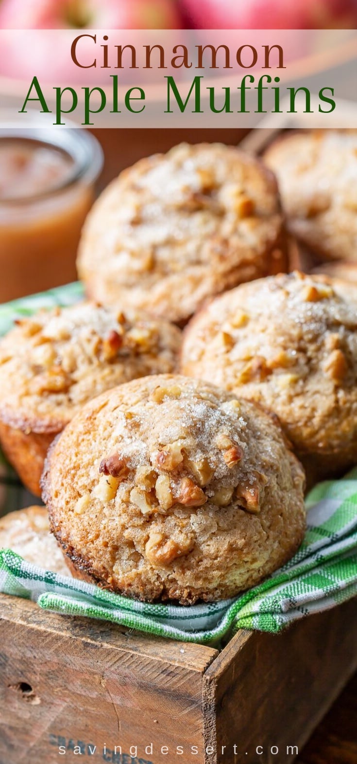A box of cinnamon apple muffins topped with walnuts and coarse sugar