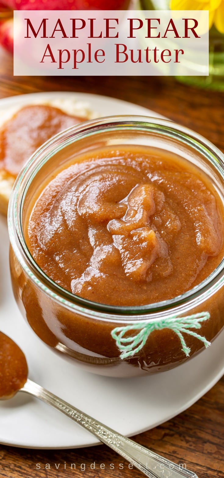 A jar of maple pear apple butter served with a biscuit