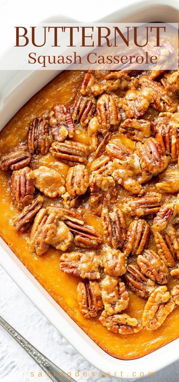 Butternut squash casserole topped with pecans