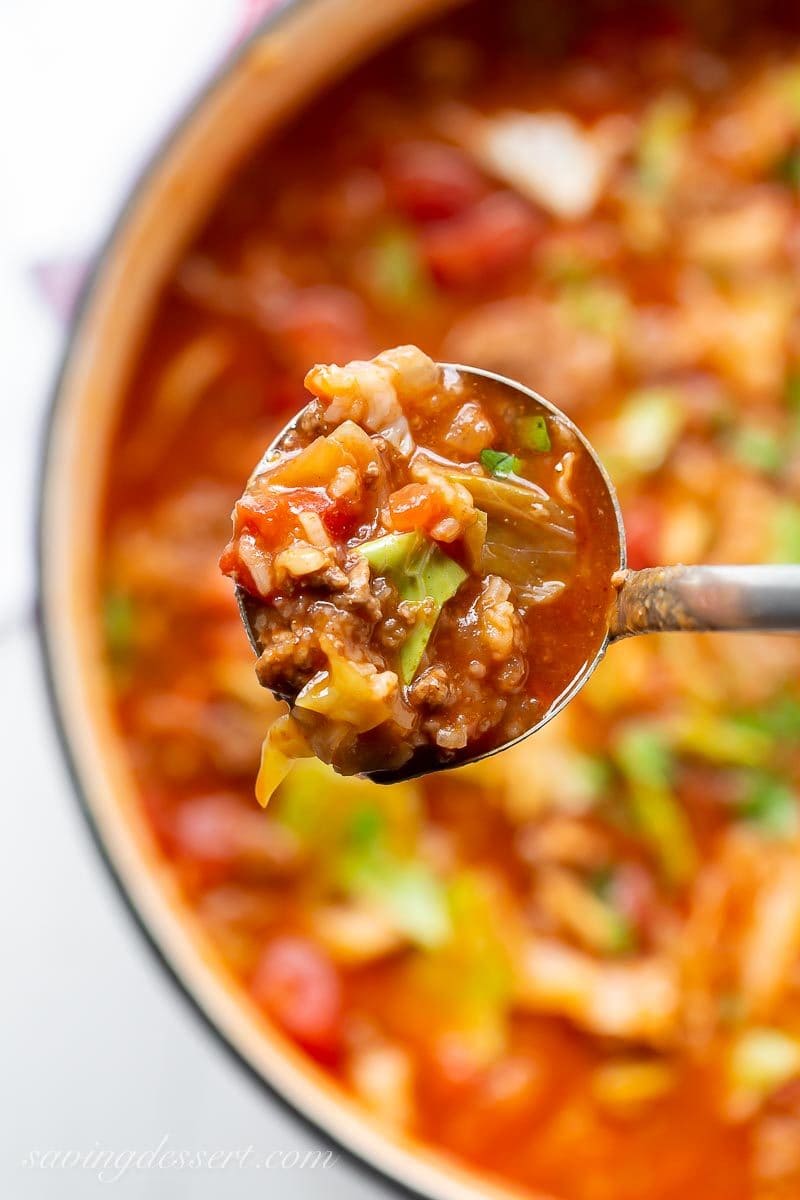 A ladle filled with cabbage roll soup