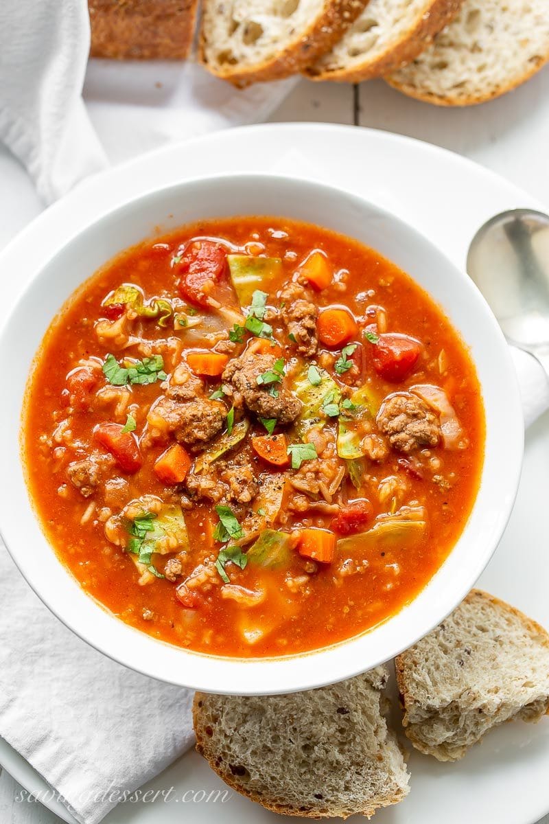 A bowl of beefy Cabbage Roll Soup with carrots, tomatoes and rice