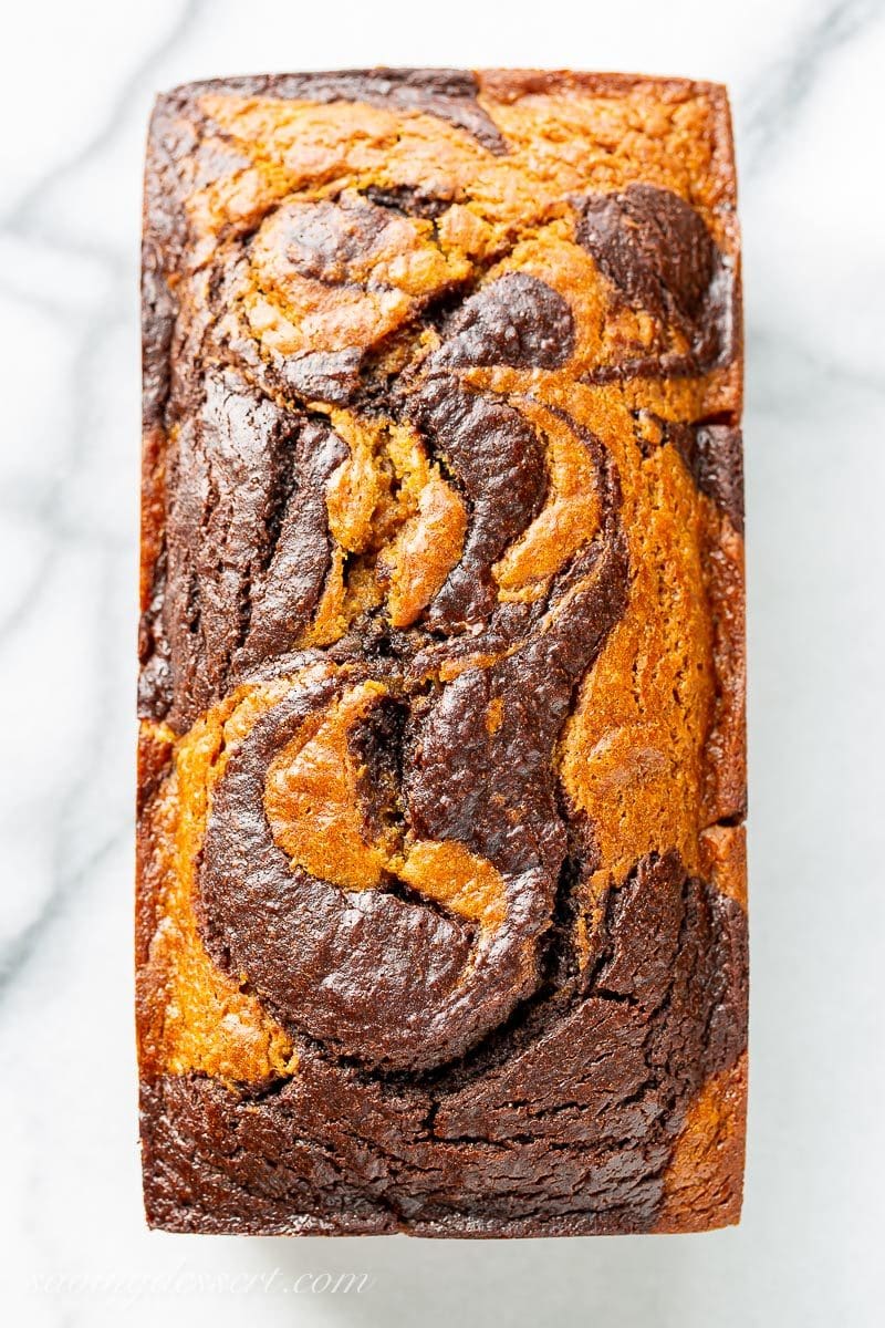 An overhead shot of a loaf of chocolate marbled pumpkin bread