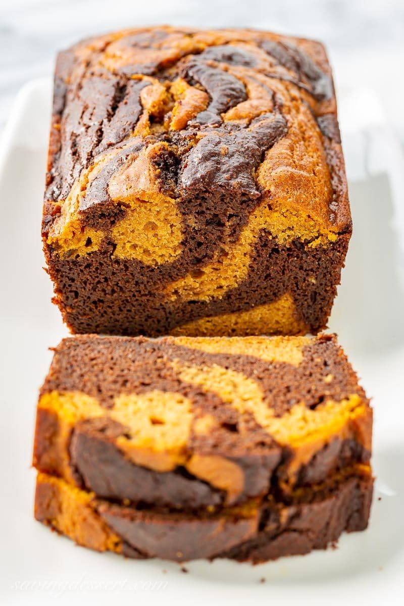 A sliced loaf of chocolate marbled pumpkin bread