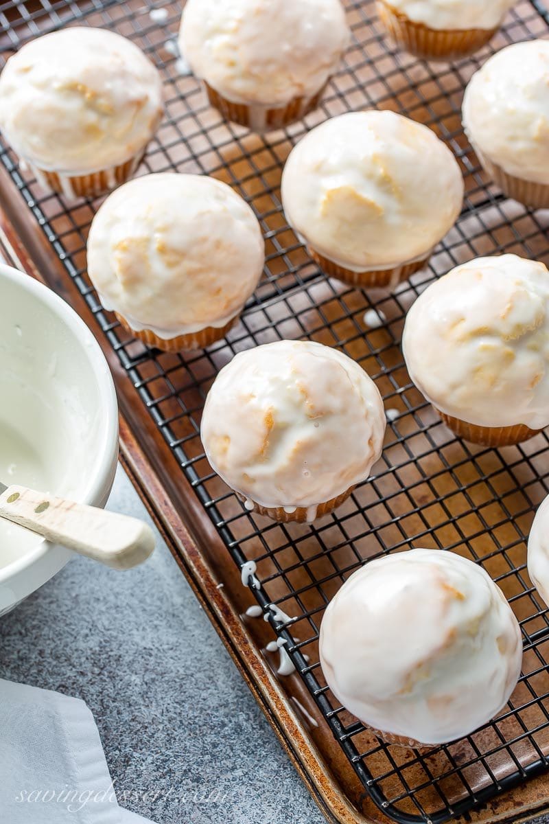 An overhead shot of donut muffins on a cooling rack with a simple vanilla glaze