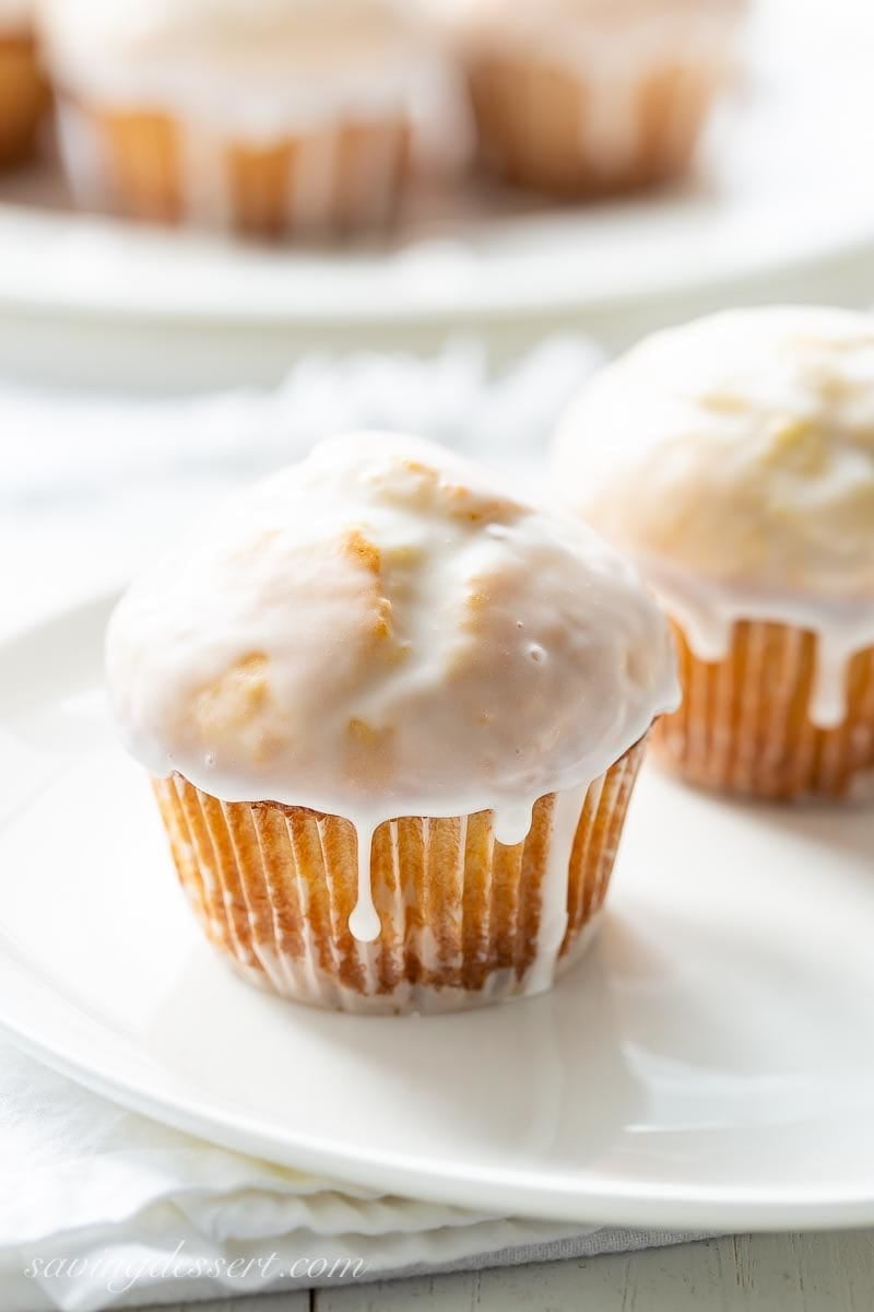 Old Fashioned Donut Muffins on a plate with a drip of icing on the side