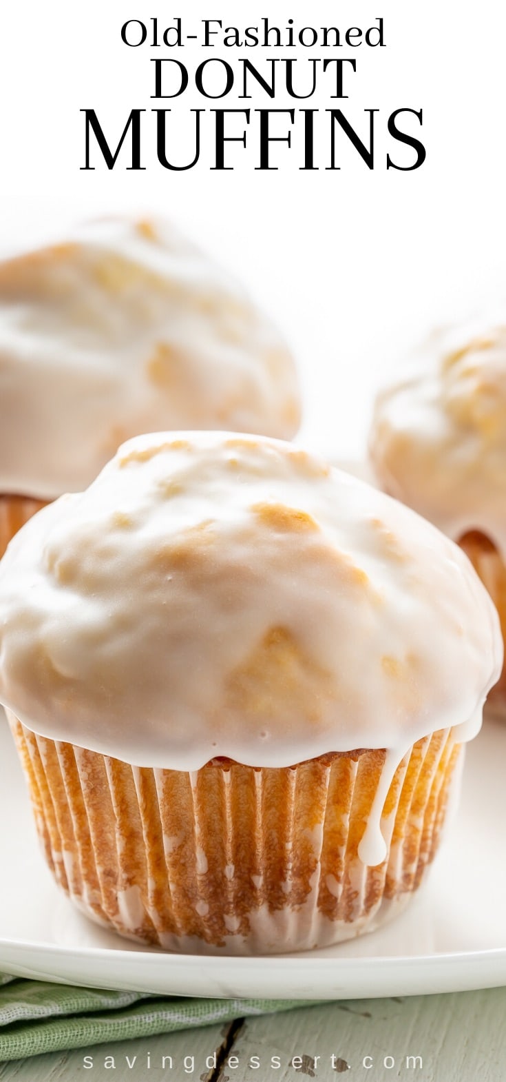 Old fashioned donut muffins on a plate with a drip of vanilla glaze on the side