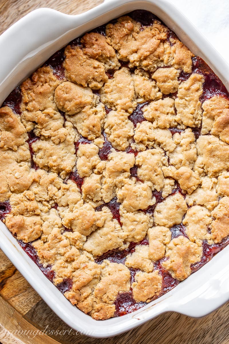 A pan of oat covered jam bars with peanut butter