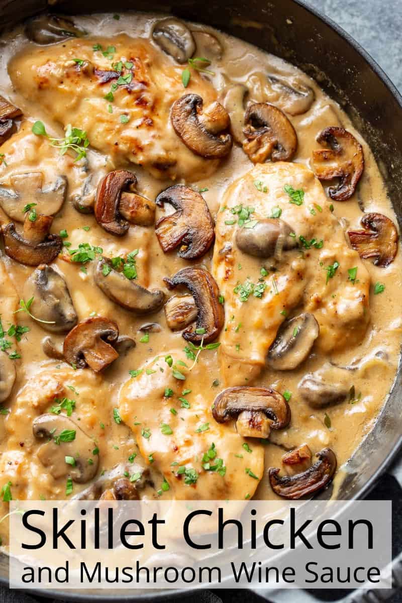 A skillet filled with chicken, mushrooms and a rich wine infused gravy