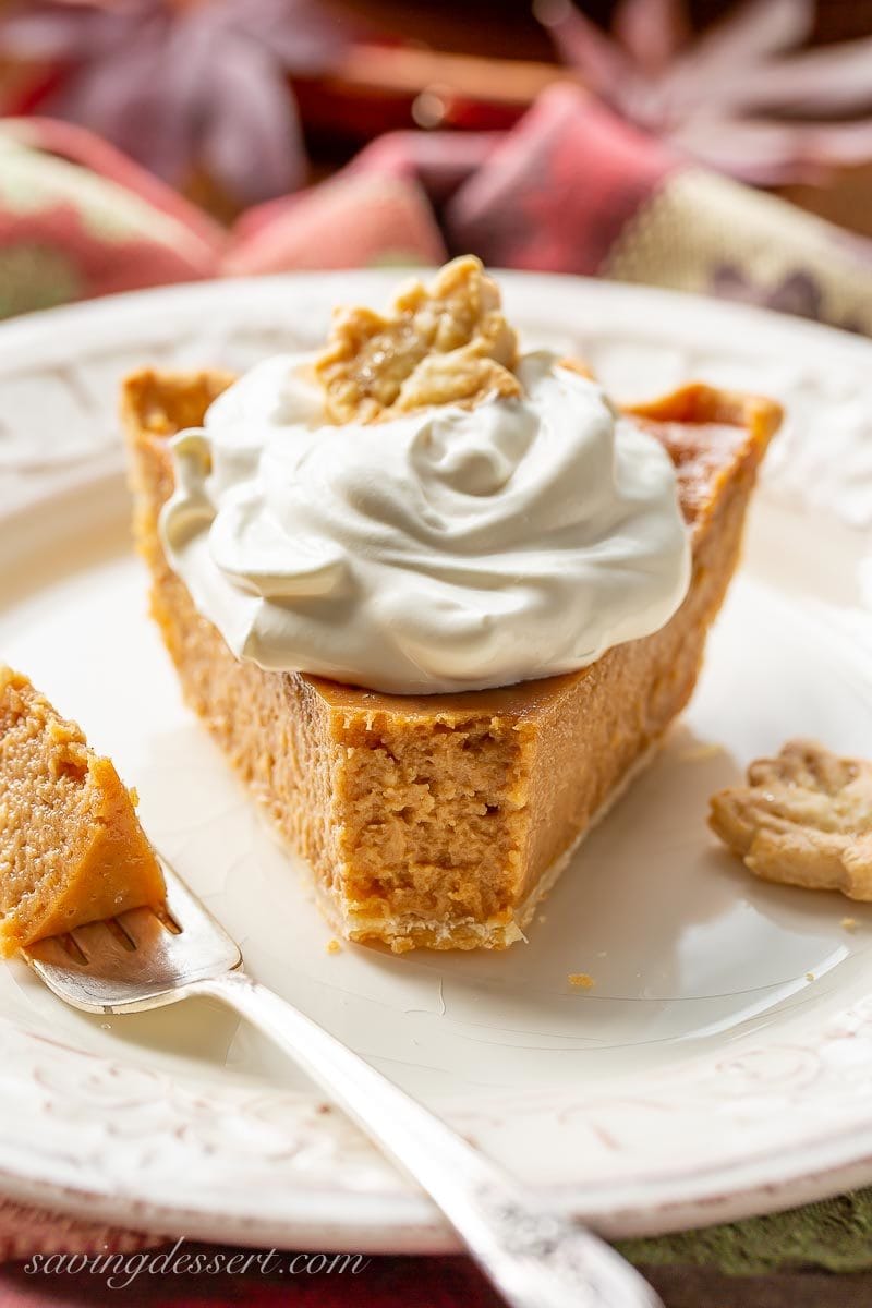 A slice of apple butter pie topped with whipped cream