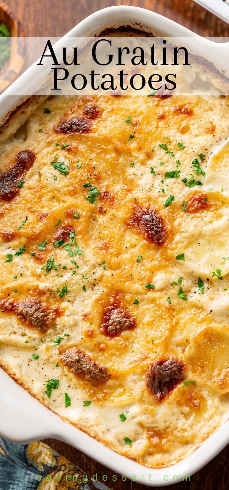 A pan filled with hot Au Gratin Potatoes recipe garnished with parsley