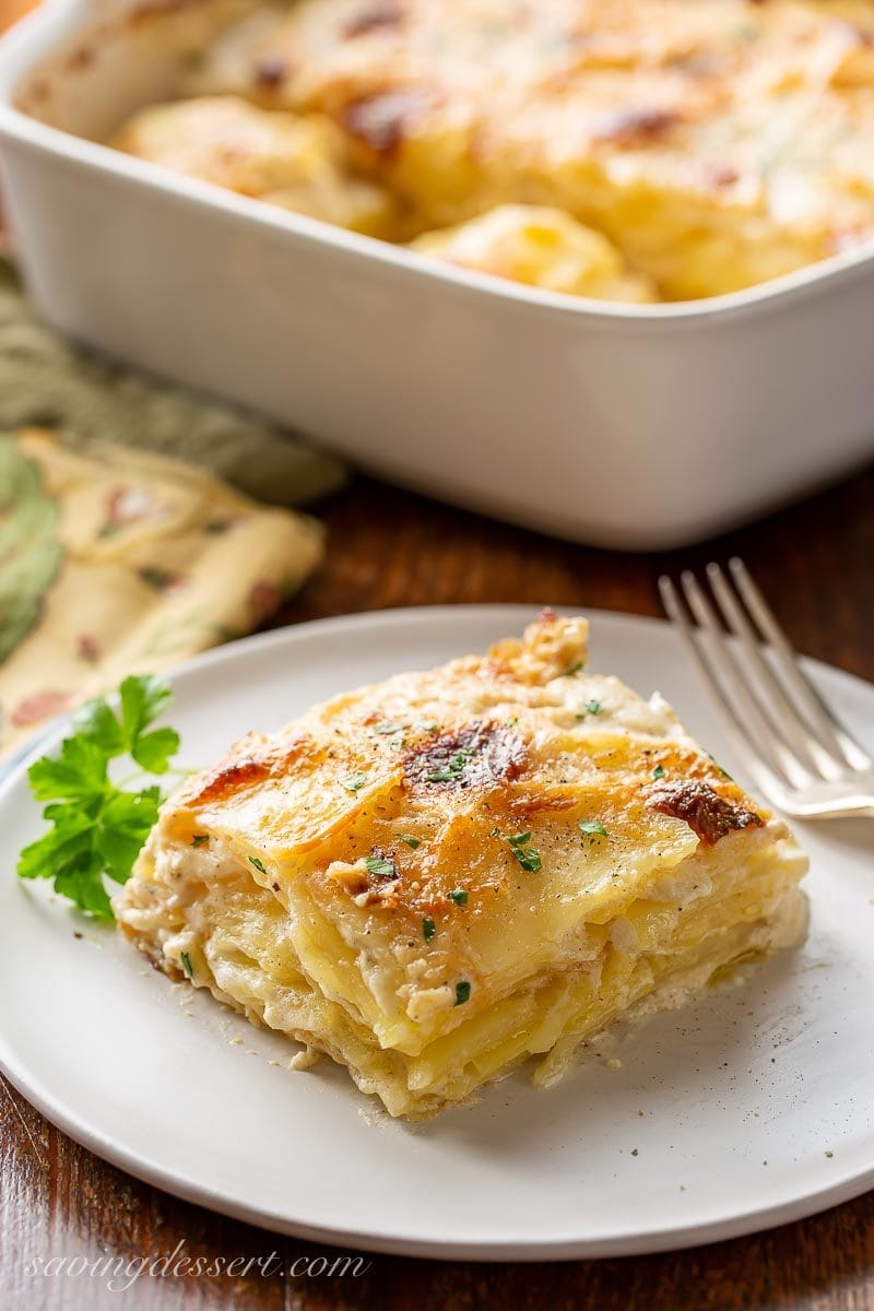 A big scoop of Au Gratin potatoes lightly browned on top garnished with parsley