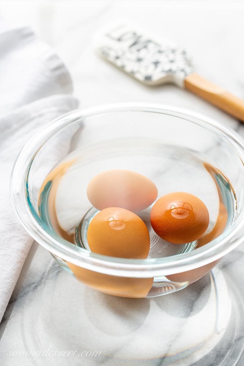 Three eggs in a bowl of warm water