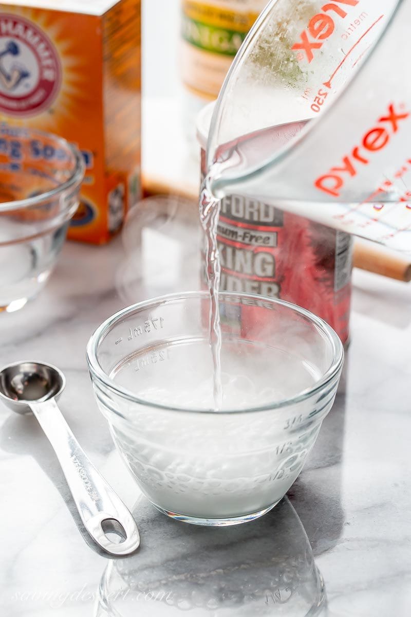 A bowl of baking powder with hot boiling water used in our best baking tips