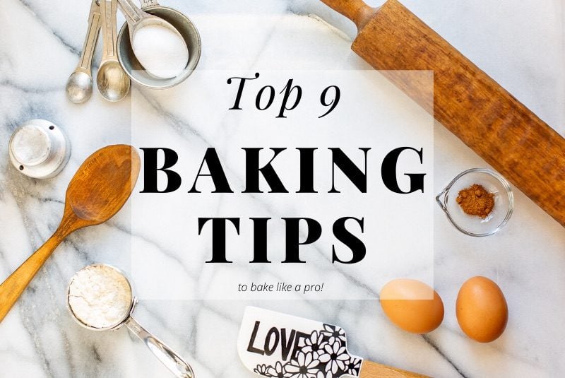 A marble pastry board with measuring cups and spoons, a rolling pin, eggs and a spatula to display our best baking tips