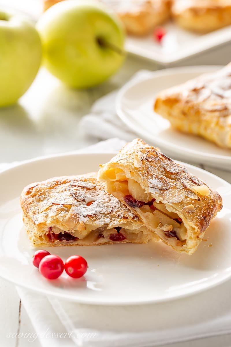 Cranberry apple puff pastry tart cut in half, on a plate