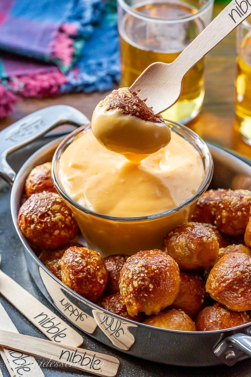 A pretzel nugget dunked in hot beer cheese dip