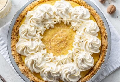 Creamy eggnog pie with swirls of whipped cream and nutmeg