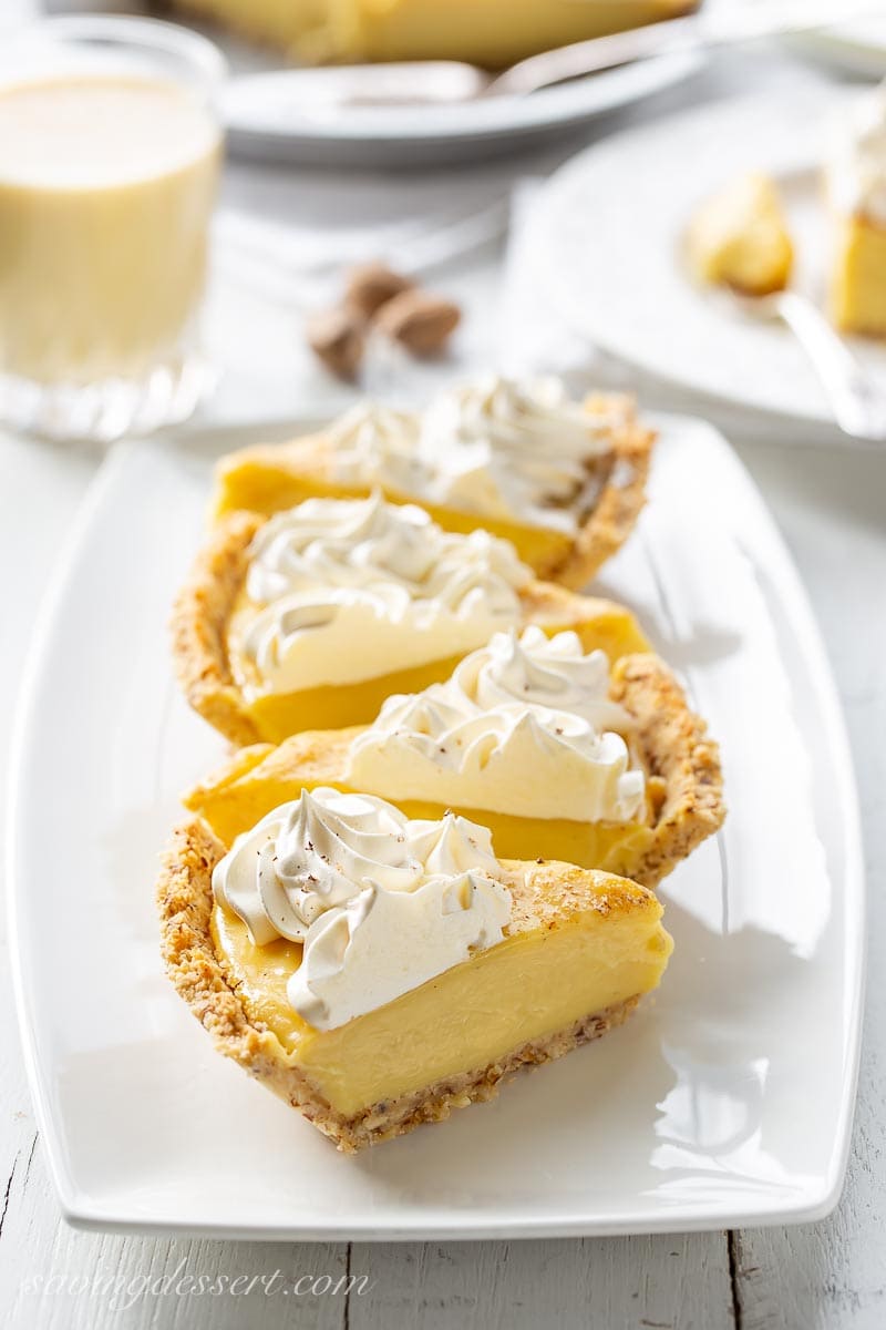 Slices of eggnog pie topped with whipped cream