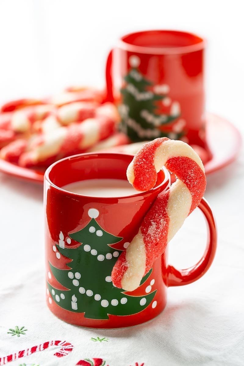 A candy cane cookie and a mug of milk