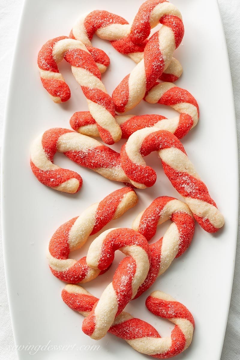 Striped cookies shaped like Candy Canes on a platter