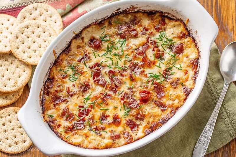 A small casserole dish with hot caramelized onion dip