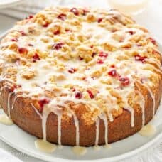 Orange Cranberry cake with a crumble top drizzled with a simple icing