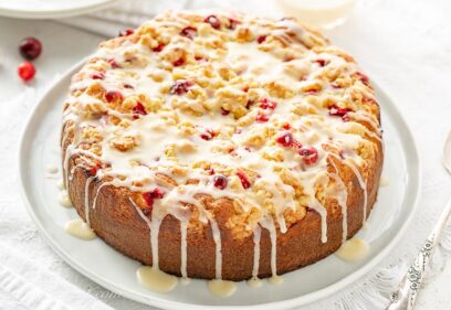 Orange Cranberry cake with a crumble top drizzled with a simple icing