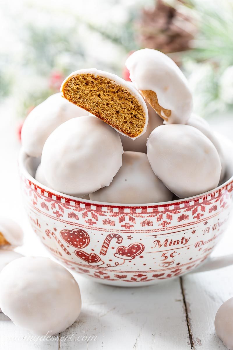 A bowl Pfeffernüsse Spice Cookies with white icing