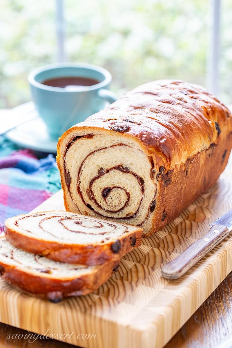 A sliced loaf of cinnamon raisin bread on a cutting board